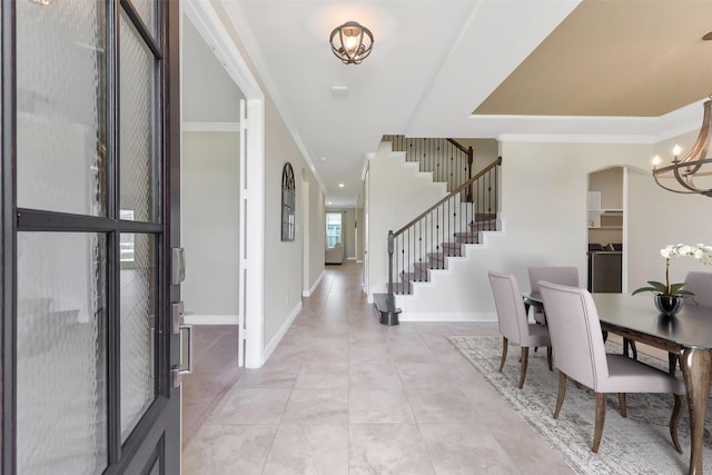 19115 Blooms Rise Dr, Tomball, TX 77377 - foyer with a chandelier, stairway, light tile patterned floors, baseboards, and ornamental molding