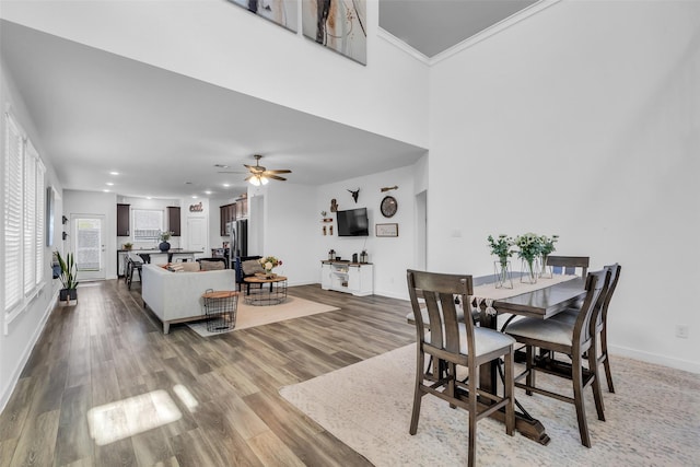 12311 Summerbrook Dr, Houston, TX 77066 - dining room featuring baseboards, wood finished floors, ceiling fan, a towering ceiling, and recessed lighting