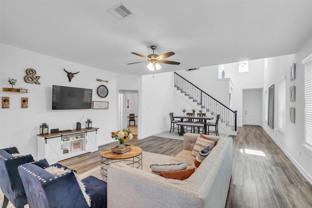 12311 Summerbrook Dr, Houston, TX 77066 - living area featuring stairway, wood finished floors, a ceiling fan, and baseboards