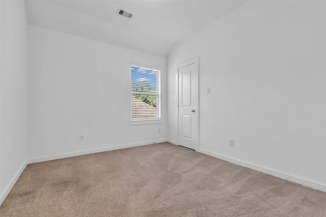 12311 Summerbrook Dr, Houston, TX 77066 - empty room featuring light colored carpet, baseboards, and lofted ceiling
