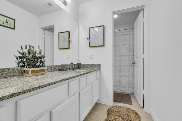 12311 Summerbrook Dr, Houston, TX 77066 - bathroom with vanity, tile patterned floors, and baseboards