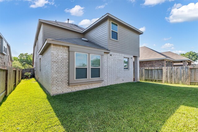 12311 Summerbrook Dr, Houston, TX 77066 - rear view of house featuring brick siding and roof with shingles