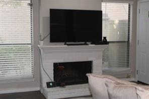 10049 Westpark Dr Unit 113, Houston, TX 77042 - living area featuring a fireplace and healthy amount of natural light