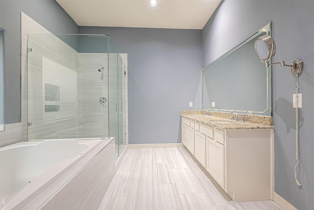 6014 Hamman St, Houston, TX 77007 - full bathroom with a stall shower, a garden tub, double vanity, and baseboards