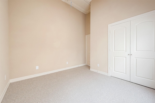 6014 Hamman St, Houston, TX 77007 - unfurnished bedroom featuring light carpet, a closet, baseboards, and crown molding