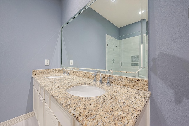 6014 Hamman St, Houston, TX 77007 - full bathroom with a stall shower, double vanity, and a textured wall