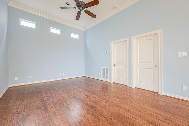 6014 Hamman St, Houston, TX 77007 - spare room featuring a ceiling fan, light wood-type flooring, crown molding, and baseboards