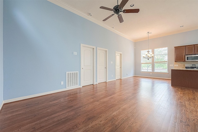 6014 Hamman St, Houston, TX 77007 - unfurnished living room with a chandelier, ceiling fan, dark wood finished floors, crown molding, and baseboards