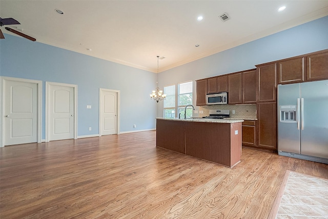 6014 Hamman St, Houston, TX 77007 - kitchen with stainless steel appliances, a chandelier, ornamental molding, light wood-style flooring, and ceiling fan