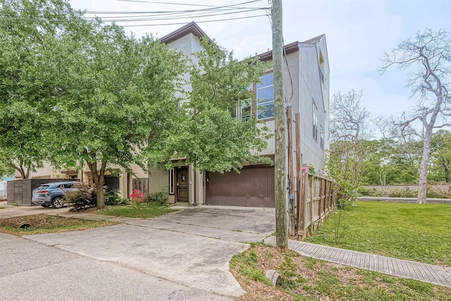 6014 Hamman St, Houston, TX 77007 - view of front facade with a garage, concrete driveway, and stucco siding