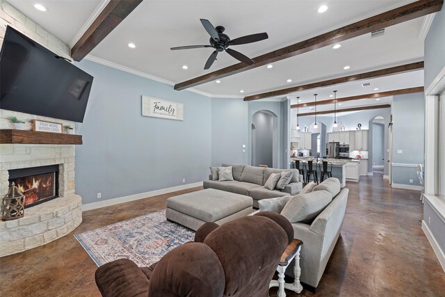 11410 Sunset Ave, Magnolia, TX 77354 - living room featuring finished concrete floors, beamed ceiling, arched walkways, a ceiling fan, and recessed lighting