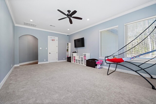 11410 Sunset Ave, Magnolia, TX 77354 - recreation room with ornamental molding, baseboards, arched walkways, carpet floors, and a ceiling fan