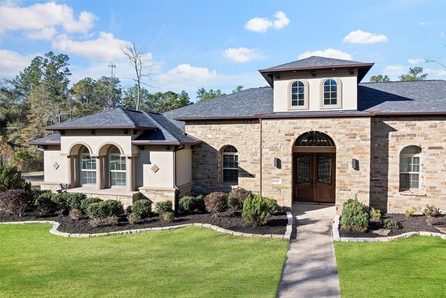 11410 Sunset Ave, Magnolia, TX 77354 - mediterranean / spanish-style home with stone siding, stucco siding, a front lawn, and a shingled roof