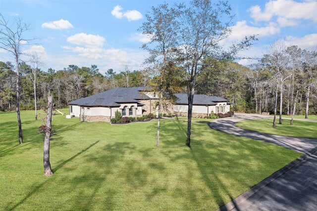 11410 Sunset Ave, Magnolia, TX 77354 - view of front facade with a front lawn and stucco siding