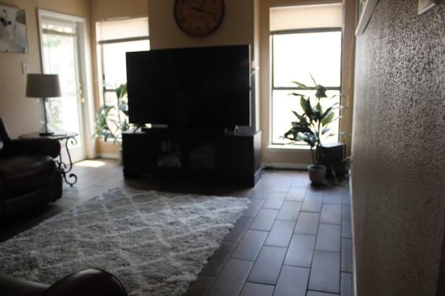 10047 Westpark Dr Unit 46, Houston, TX 77042 - living area featuring plenty of natural light and dark tile patterned floors