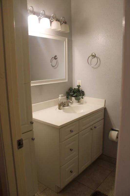 10047 Westpark Dr Unit 46, Houston, TX 77042 - bathroom with vanity and tile patterned flooring