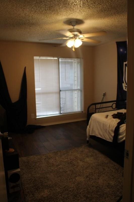 10047 Westpark Dr Unit 46, Houston, TX 77042 - bedroom featuring a textured ceiling, wood finished floors, and ceiling fan