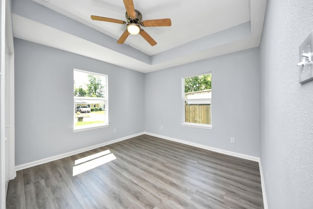 1707 Wilburn, Baytown, TX 77520 - empty room with wood finished floors, baseboards, a raised ceiling, and a ceiling fan