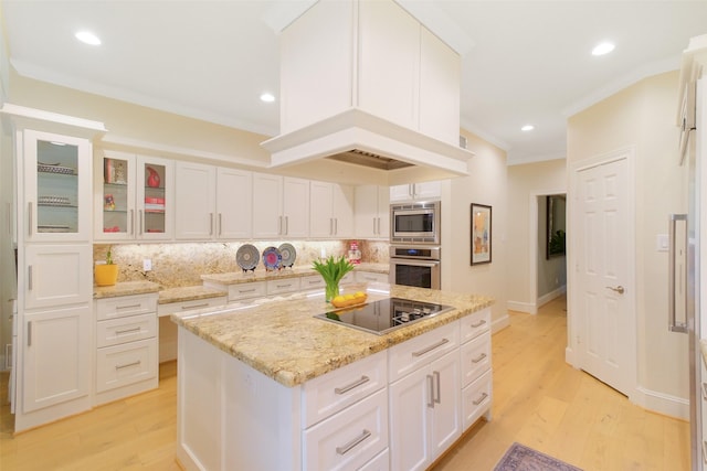 513 Rancho Bauer Dr, Houston, TX 77079 - kitchen featuring stainless steel appliances, decorative backsplash, white cabinets, crown molding, and light wood-style flooring