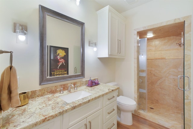 513 Rancho Bauer Dr, Houston, TX 77079 - bathroom featuring a shower stall, toilet, wood finished floors, and vanity