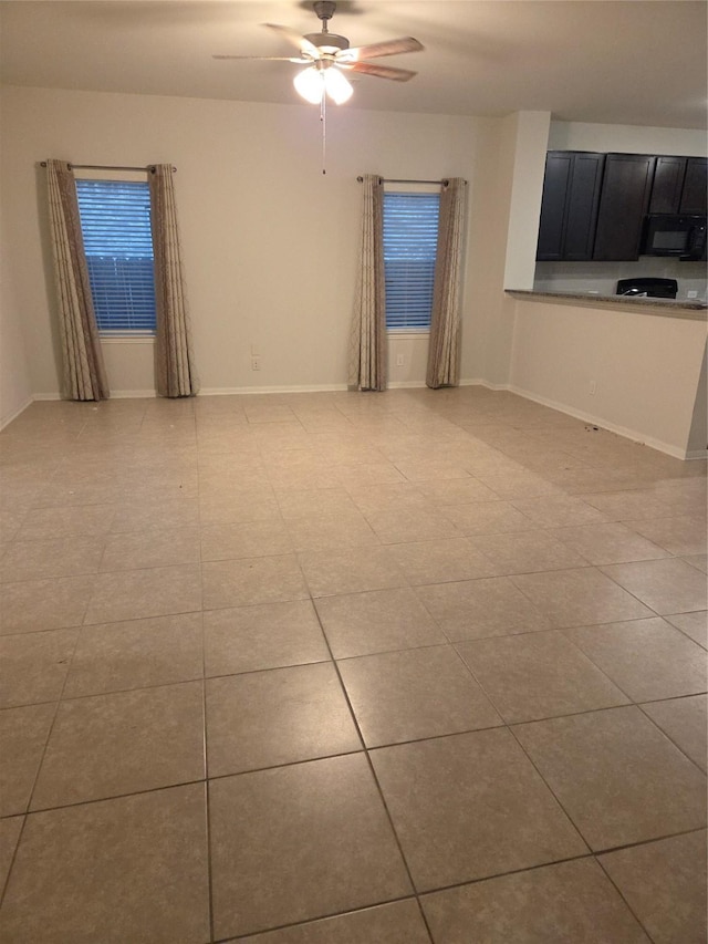 10010 Pine Valley Ct, Baytown, TX 77521 - empty room with a ceiling fan and light tile patterned floors
