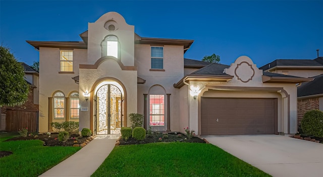 5411 Oban Terrace Ln, Sugar Land, TX 77479 - mediterranean / spanish-style house featuring an attached garage, driveway, stucco siding, and a front lawn