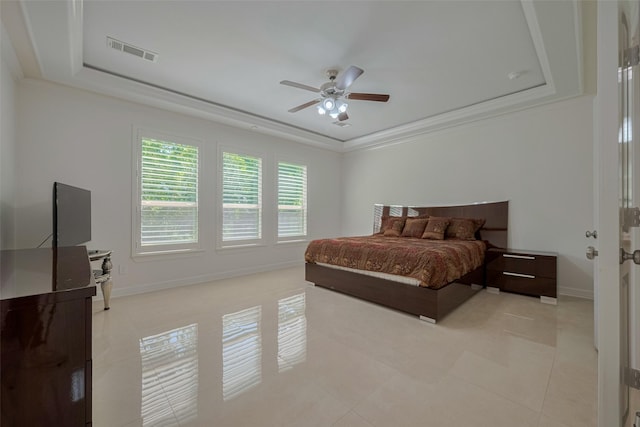 5411 Oban Terrace Ln, Sugar Land, TX 77479 - bedroom featuring a tray ceiling, light tile patterned floors, a ceiling fan, baseboards, and crown molding