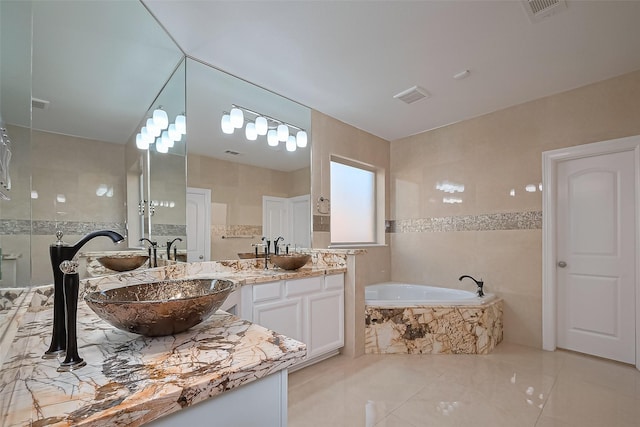 5411 Oban Terrace Ln, Sugar Land, TX 77479 - bathroom featuring a garden tub, tile patterned floors, and vanity