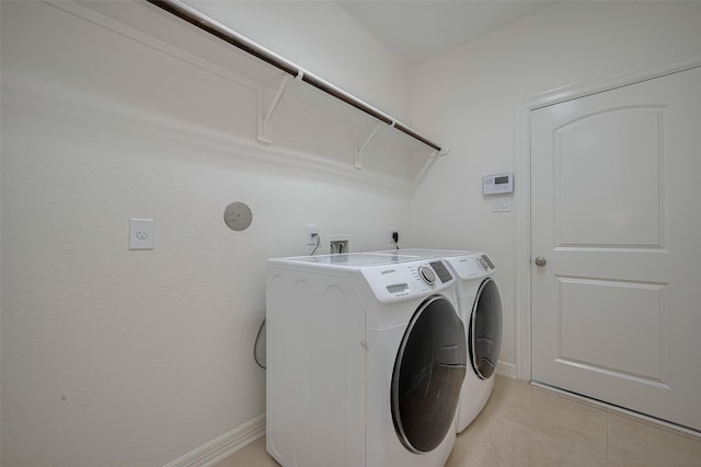 5411 Oban Terrace Ln, Sugar Land, TX 77479 - washroom featuring independent washer and dryer, light tile patterned flooring, and baseboards