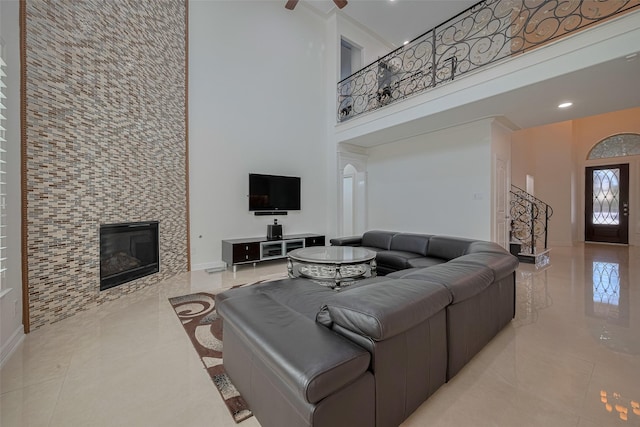 5411 Oban Terrace Ln, Sugar Land, TX 77479 - tiled living room with a towering ceiling, a tile fireplace, recessed lighting, and baseboards