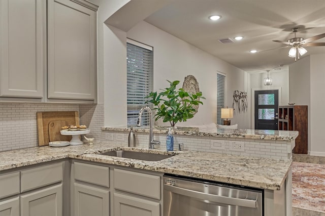 106 Emory Birch Dr, Montgomery, TX 77316 - kitchen featuring stainless steel dishwasher, a sink, backsplash, ceiling fan, and a peninsula