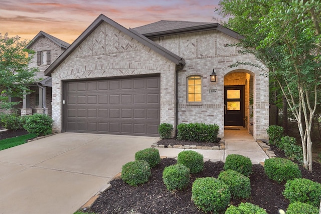 106 Emory Birch Dr, Montgomery, TX 77316 - french country inspired facade with a garage, brick siding, and concrete driveway