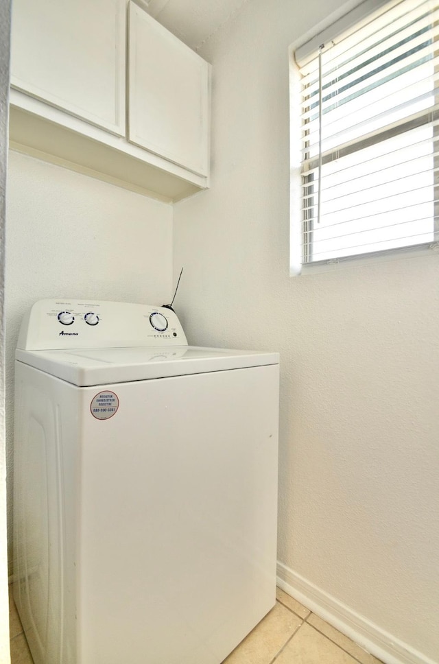 1516 Bay Area Blvd Unit C6, Houston, TX 77058 - laundry area featuring washer / clothes dryer, cabinet space, light tile patterned flooring, and baseboards