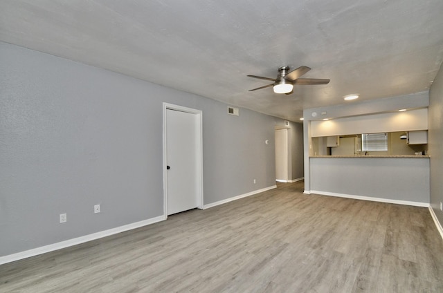 1516 Bay Area Blvd Unit C6, Houston, TX 77058 - unfurnished living room featuring ceiling fan, light wood-type flooring, and baseboards