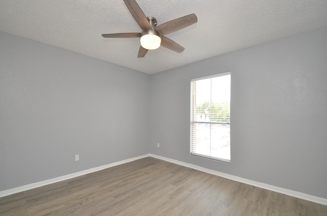 1516 Bay Area Blvd Unit C6, Houston, TX 77058 - unfurnished room with wood finished floors, ceiling fan, a textured ceiling, and baseboards
