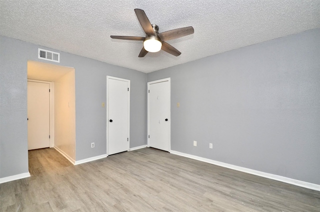 1516 Bay Area Blvd Unit C6, Houston, TX 77058 - unfurnished bedroom featuring wood finished floors, a textured ceiling, baseboards, and ceiling fan