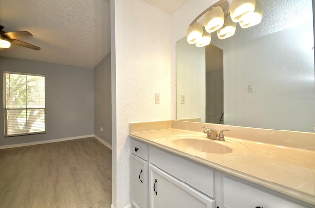 1516 Bay Area Blvd Unit C6, Houston, TX 77058 - bathroom featuring wood finished floors, vanity, ceiling fan, a textured wall, and baseboards
