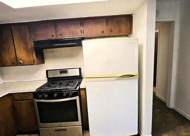 6315 Mardale Dr, Houston, TX 77016 - kitchen featuring freestanding refrigerator, stainless steel range with gas stovetop, light countertops, under cabinet range hood, and dark brown cabinets