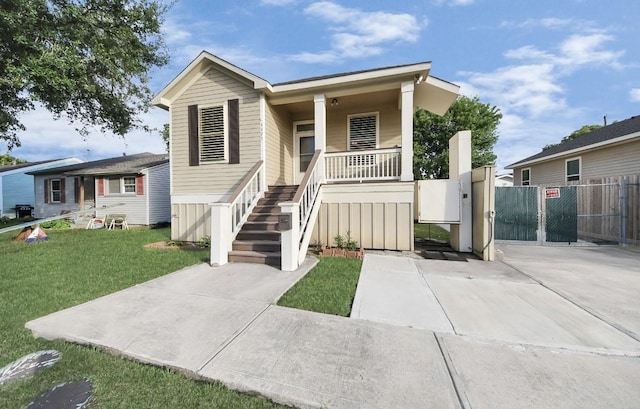 5323 Menard Ave, Galveston, TX 77551 - view of front of house featuring covered porch, stairway, and a gate