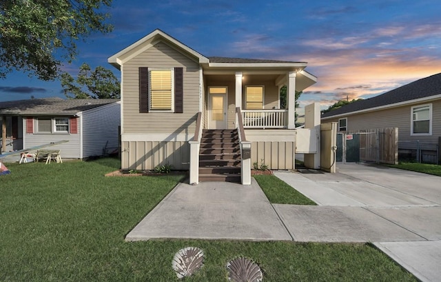 5323 Menard Ave, Galveston, TX 77551 - view of front of house with a yard, covered porch, and stairway