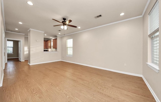5323 Menard Ave, Galveston, TX 77551 - unfurnished living room with crown molding, healthy amount of natural light, a ceiling fan, recessed lighting, and baseboards