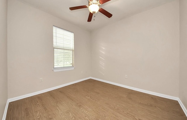 5323 Menard Ave, Galveston, TX 77551 - empty room with dark wood-style floors, baseboards, and ceiling fan