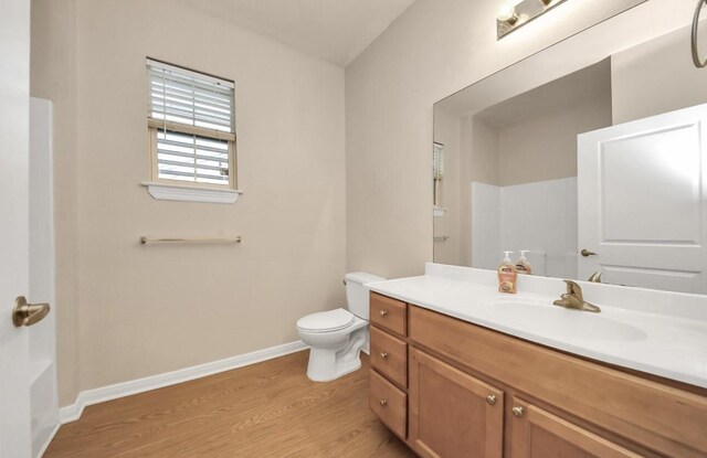 5323 Menard Ave, Galveston, TX 77551 - full bathroom with wood finished floors, baseboards, toilet, and vanity