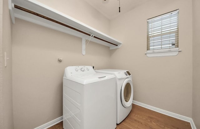 5323 Menard Ave, Galveston, TX 77551 - clothes washing area with independent washer and dryer, baseboards, and wood finished floors