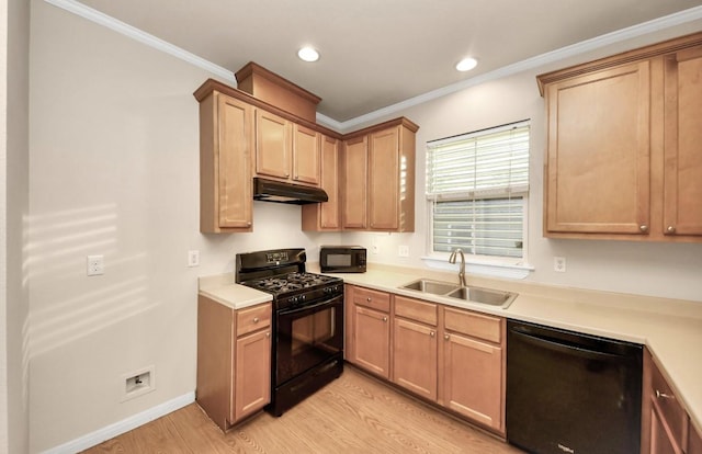 5323 Menard Ave, Galveston, TX 77551 - kitchen with black appliances, a sink, under cabinet range hood, light wood-type flooring, and light countertops