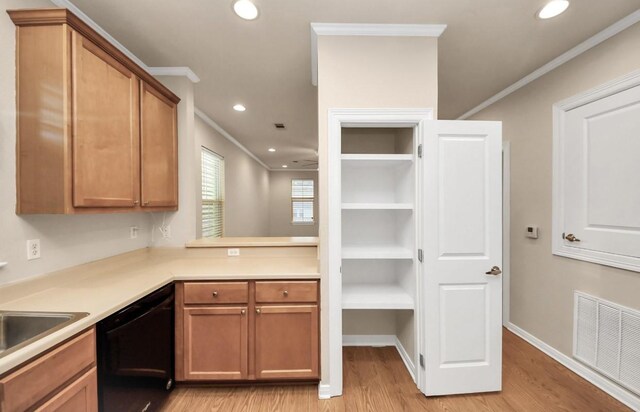 5323 Menard Ave, Galveston, TX 77551 - kitchen with dishwasher, ornamental molding, light wood finished floors, recessed lighting, and light countertops