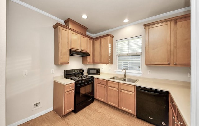 5323 Menard Ave, Galveston, TX 77551 - kitchen with black appliances, a sink, light wood-style floors, under cabinet range hood, and light countertops
