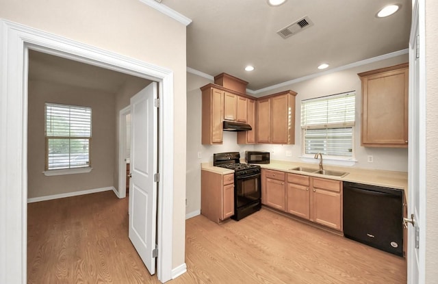 5323 Menard Ave, Galveston, TX 77551 - kitchen featuring black appliances, a sink, under cabinet range hood, light wood-type flooring, and light countertops