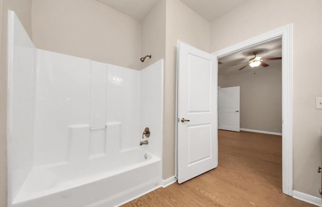 5323 Menard Ave, Galveston, TX 77551 - full bath featuring wood finished floors, a ceiling fan, baseboards, and shower / washtub combination