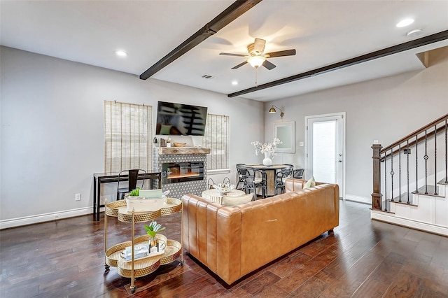 3108 Rogers St, Houston, TX 77022 - living area featuring a brick fireplace, beamed ceiling, stairway, hardwood / wood-style floors, and a ceiling fan